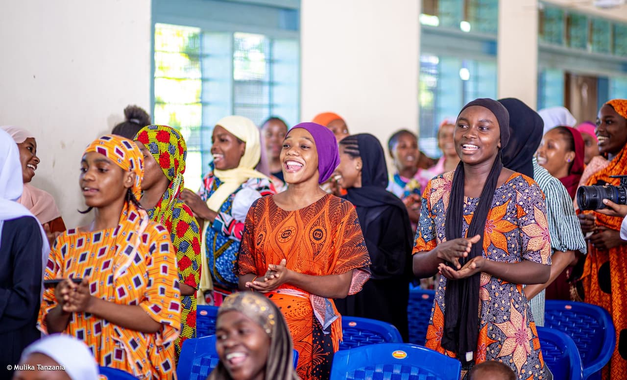 YEE members laughing and applauding during a community session